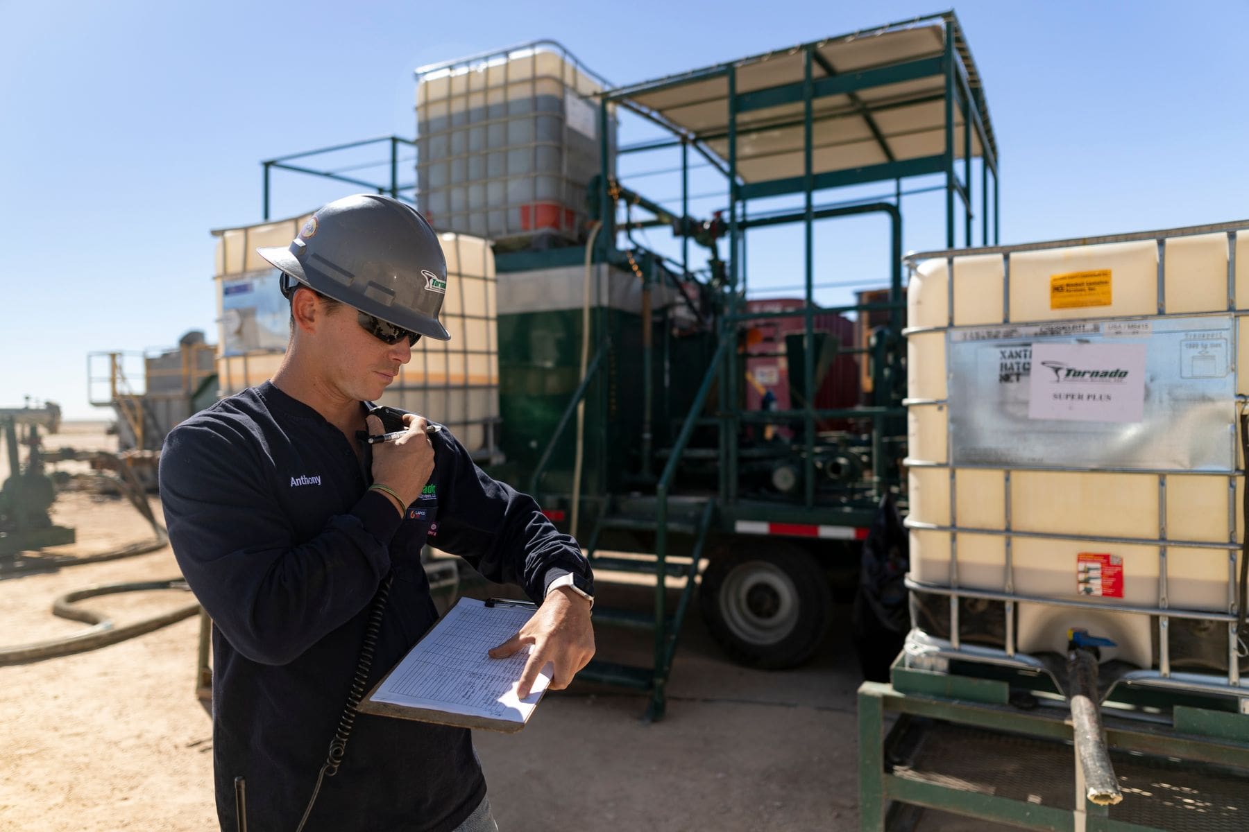 Man standing by a mixing plant with a clipboard